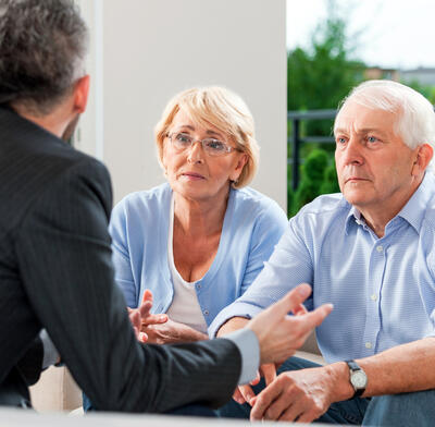 Retired couple discuss with financial advisor
