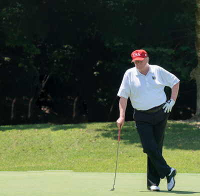 Donald Trump on the putting green at a golf course