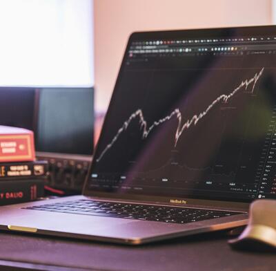 Laptop displaying rising price chart